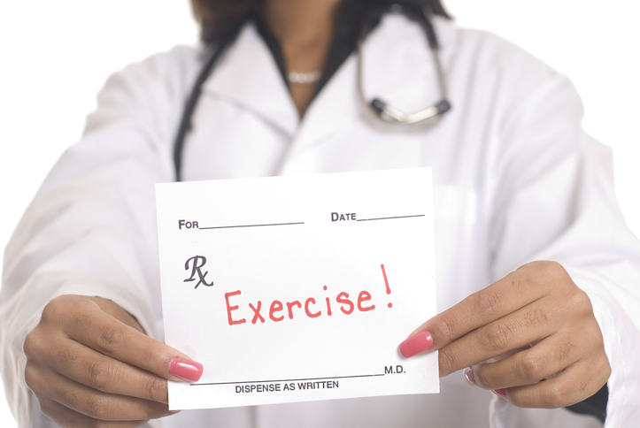 A doctor holding a prescription saying exercise